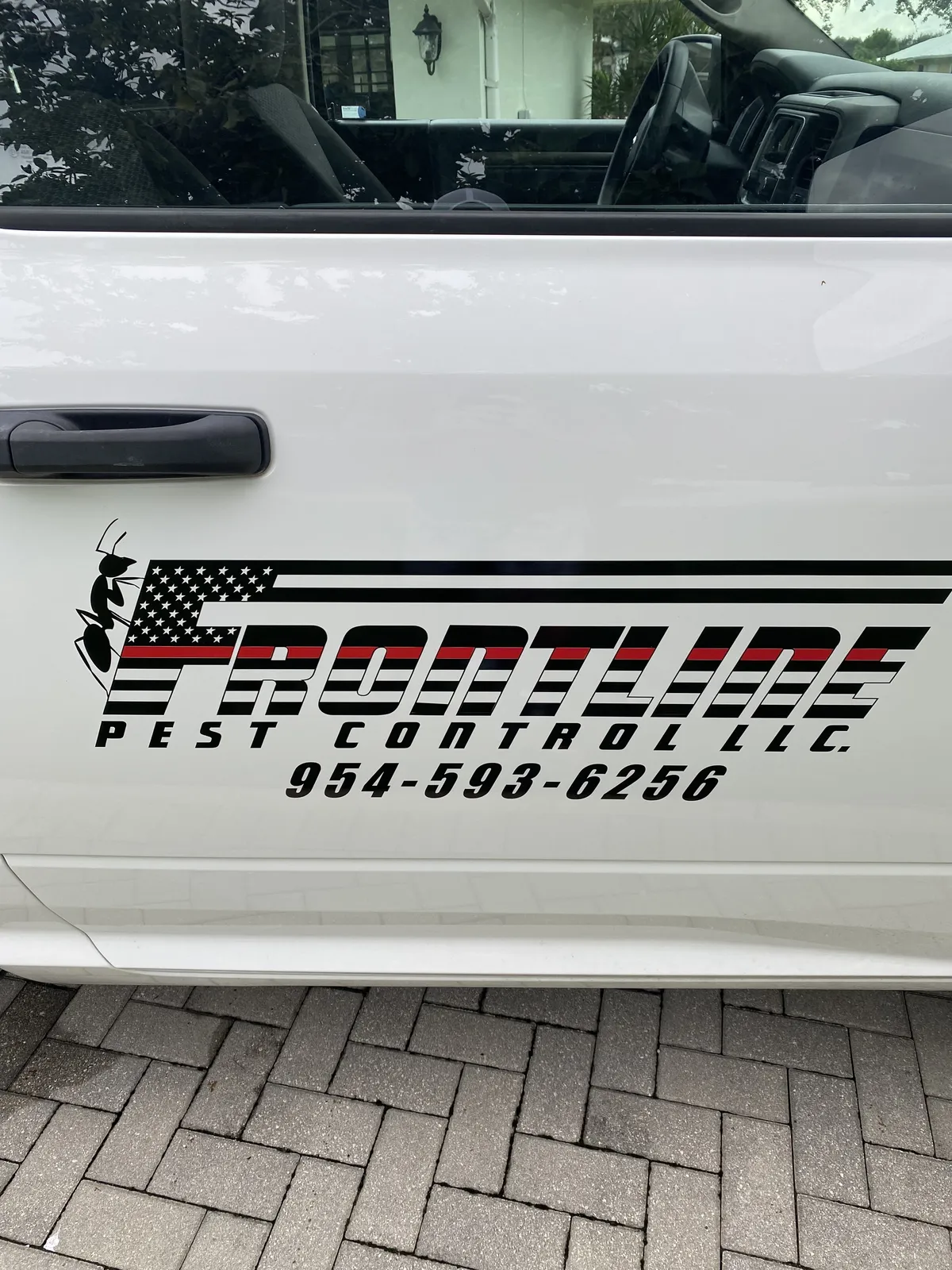 Frontline Pest Control logo on the service truck door