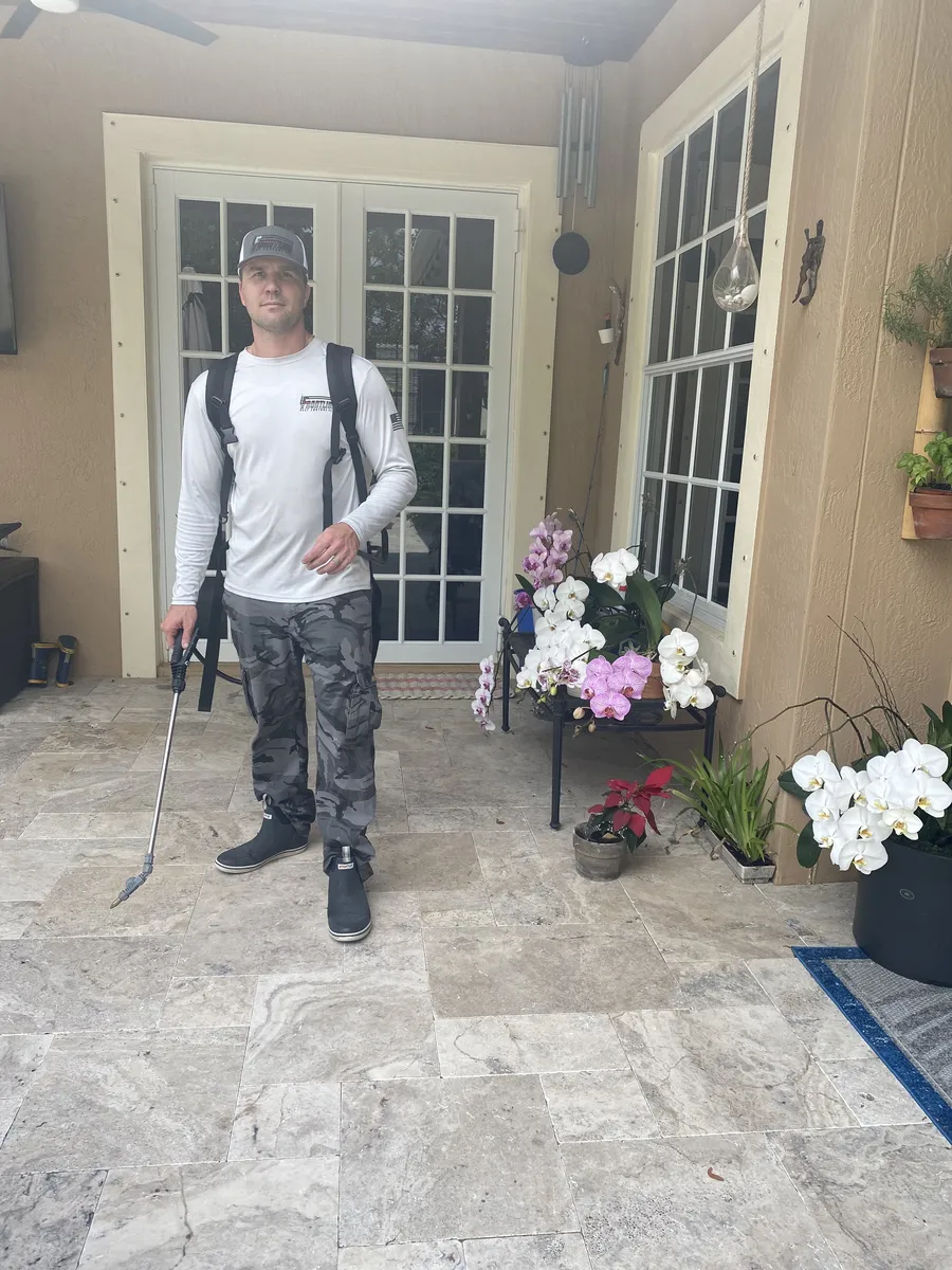 Technician treating a patio for household pests