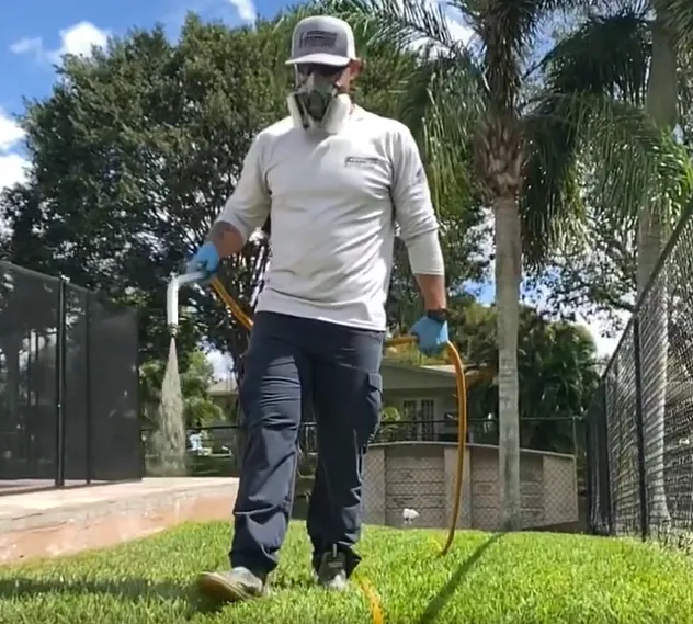 Technician spraying a lawn for weed control